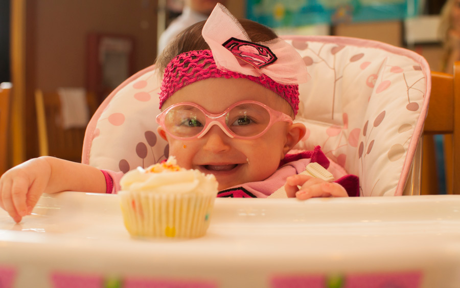 Hazel is pleased with her first cupcake for her birthday
